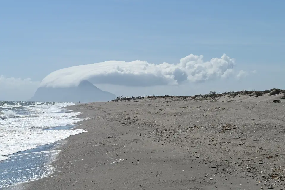 The Rock of Gibraltar under a cap of cloud, seen from the beach south of Sotogrande