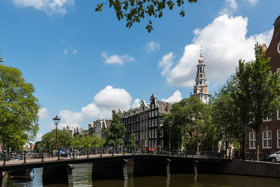 A canal bridge on the Kloveniersburgwal in Amsterdam with the Zuiderkerk tower behind
