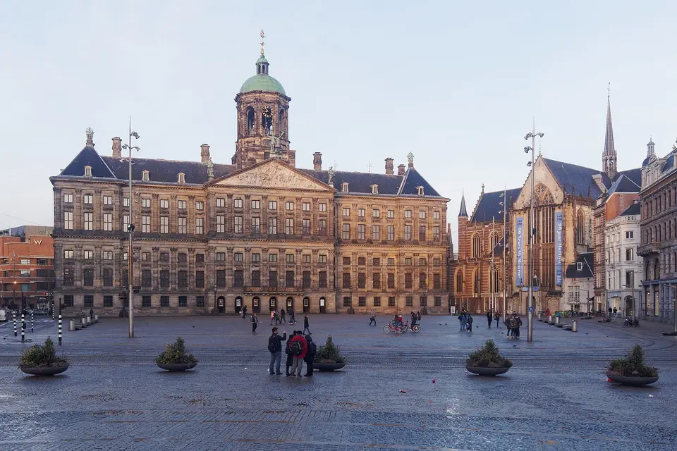 The Royal Palace and Nieuwe Kerk across the open paving of Dam Square in Amsterdam