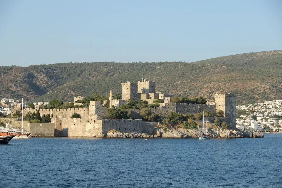 Bodrum Castle seen from the sea, with its towers above the harbour and hills behind