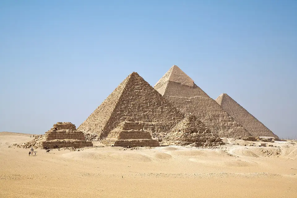 The Giza pyramids lined up across the plateau, with the small queens' pyramids in front