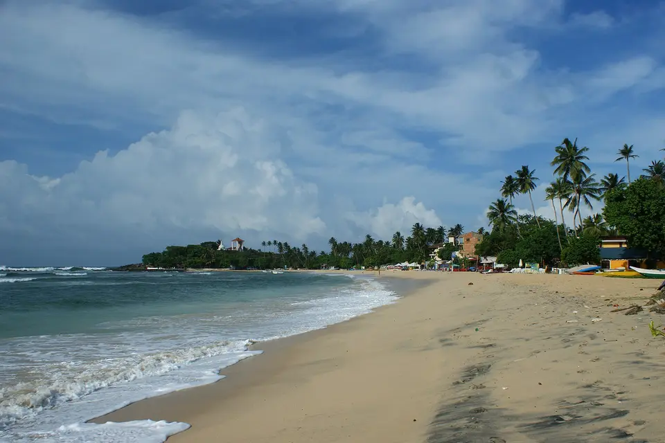 The sandy curve of Unawatuna beach, a few kilometres east of Galle
