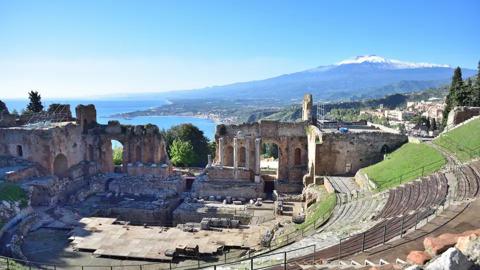 The ancient theatre of Taormina with Mount Etna and the coast beyond