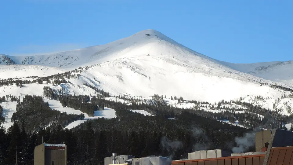 Snow-covered Peak 8 above the forested ski slopes of Breckenridge Ski Resort in winter