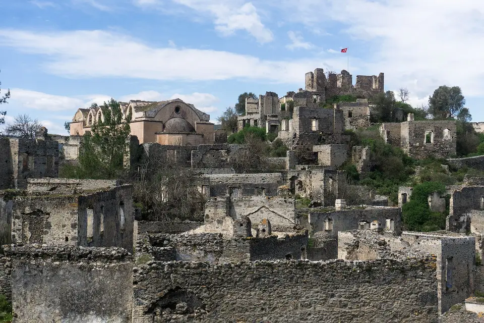 Roofless stone houses and a church in the abandoned hillside village of Kayaköy near Fethiye
