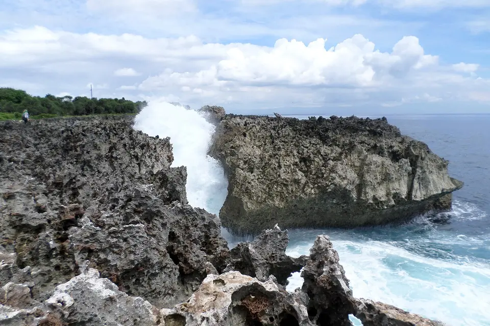 Waves bursting up through a gap in the coral rocks at Water Blow, Nusa Dua