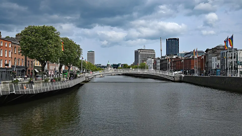 The River Liffey in central Dublin, with the Ha'penny Bridge and riverside buildings in the distance