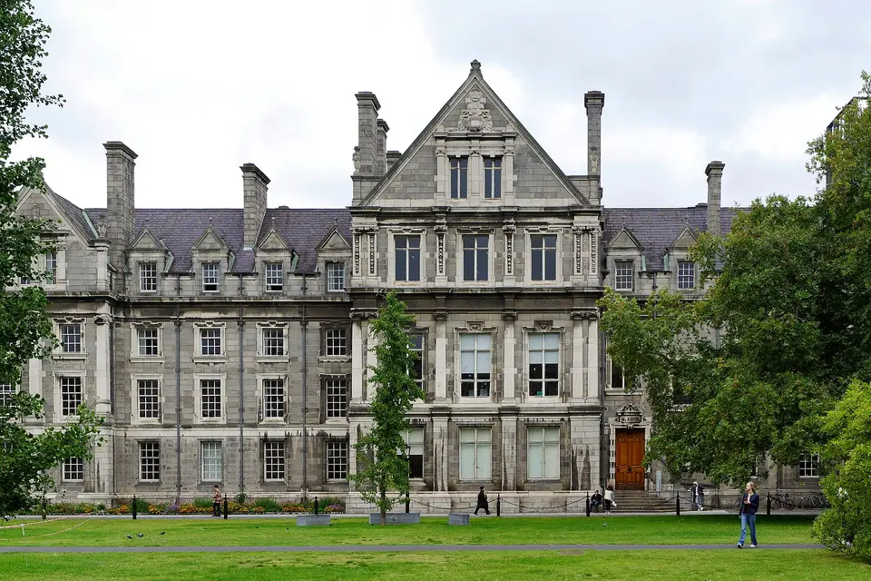 The Graduates Memorial Building at Trinity College Dublin, a Victorian stone facade framed by trees