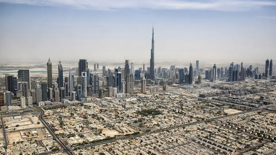 Downtown Dubai skyline with the Burj Khalifa rising above low-rise districts on a hazy day
