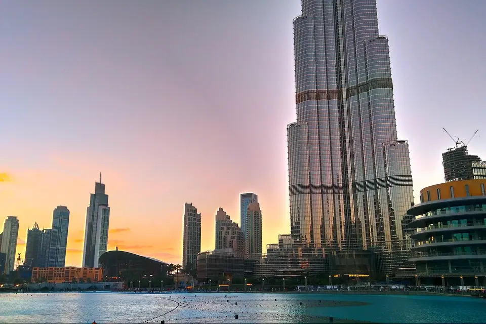 The Burj Khalifa and neighbouring towers under a pink and orange sunset sky