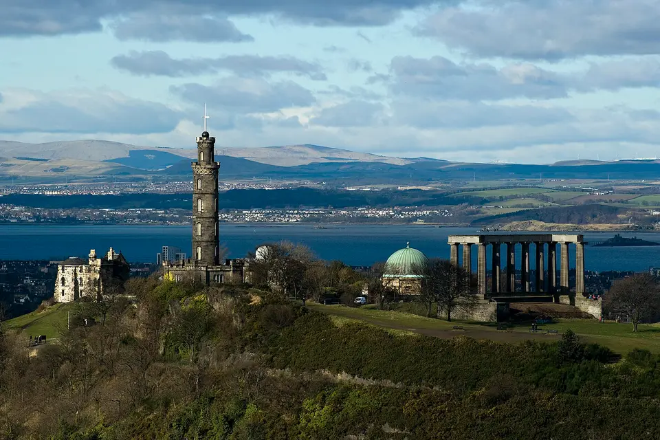 Calton Hill in Edinburgh with the Nelson Monument and National Monument above the Firth of Forth