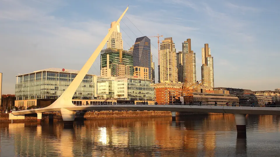 Puente de la Mujer footbridge and Puerto Madero towers reflected in the dock at sunset, Buenos Aires