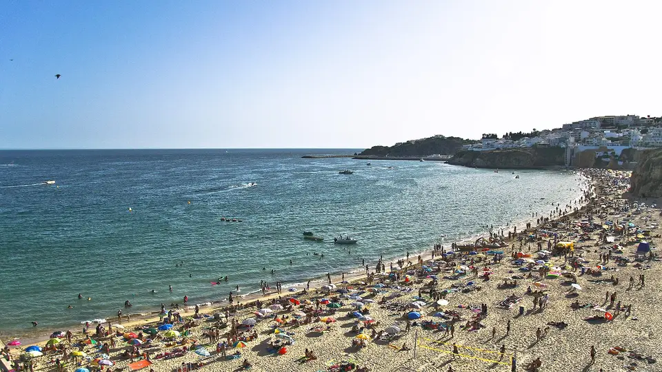 Praia dos Pescadores on a summer day, with Albufeira old town on the cliffs beyond