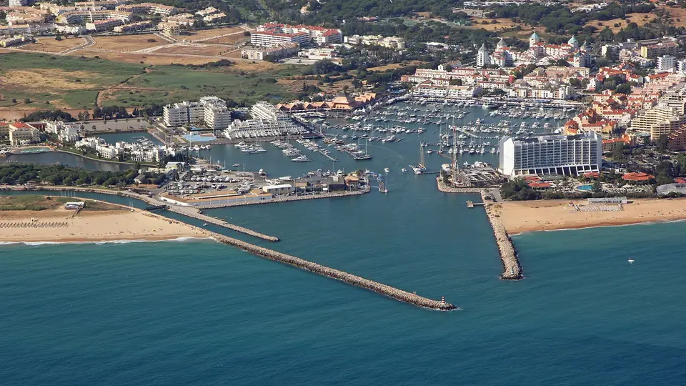 Aerial view of Vilamoura Marina, its breakwaters and the beaches on either side of the harbour entrance