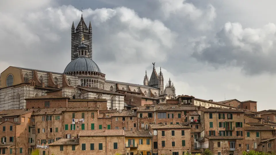 Siena's rooftops with the striped bell tower and dome of the cathedral