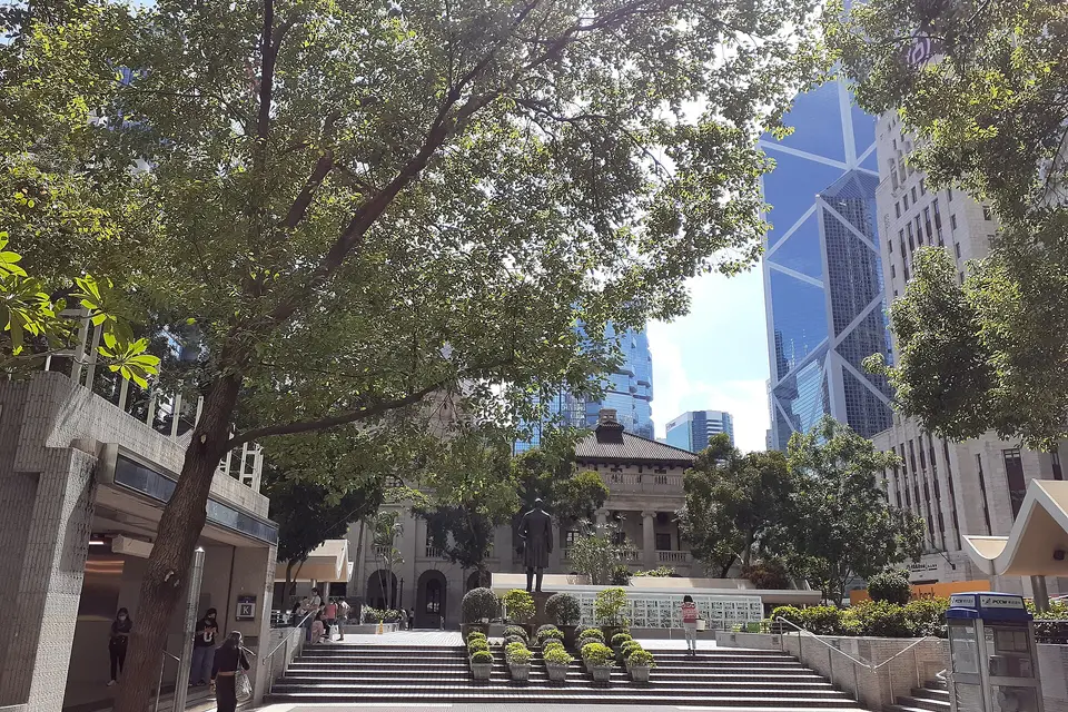 Statue Square Gardens in Central, Hong Kong, with the Bank of China Tower beyond the trees