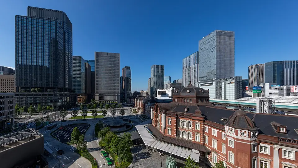 Tokyo Station's red-brick Marunouchi building and plaza, surrounded by glass office towers