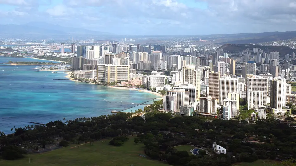 The high-rise hotels and curving shoreline of Waikiki seen from the rim of Diamond Head