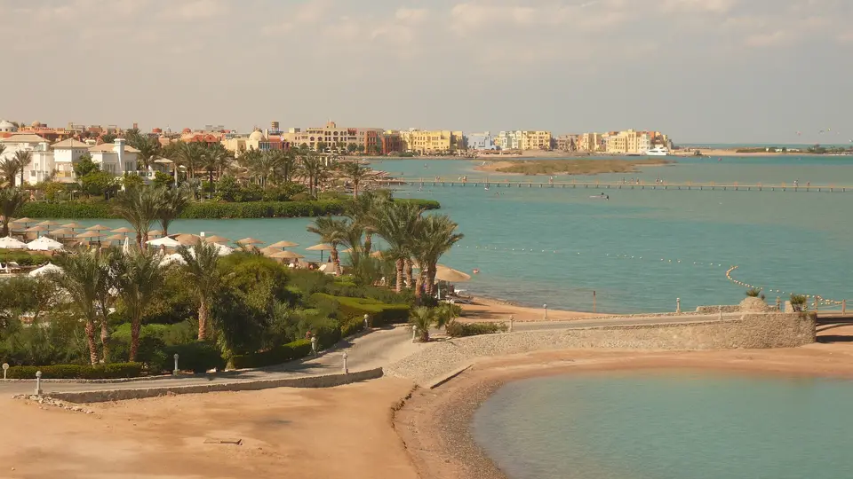 Palm-lined beach and turquoise Red Sea lagoon at El Gouna with the town beyond