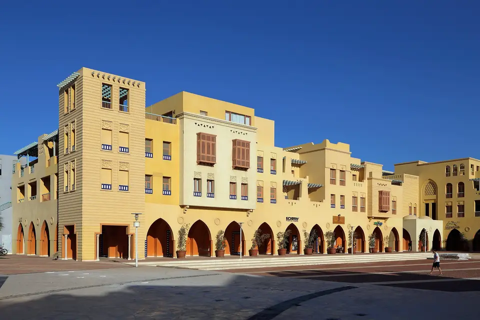 Arcaded buildings in warm yellow tones beside Abu Tig Marina, El Gouna