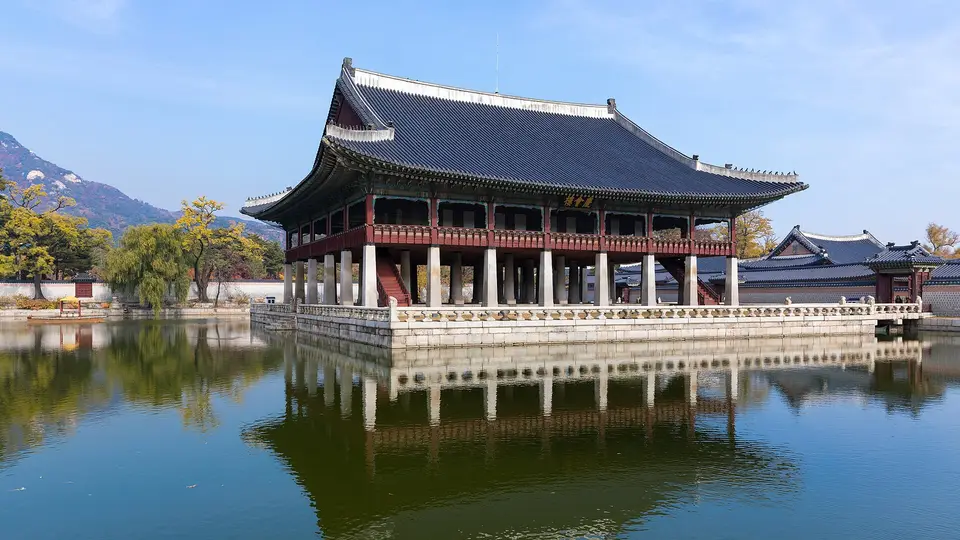 Gyeonghoeru pavilion at Gyeongbokgung Palace in Seoul, reflected in its pond under a blue sky