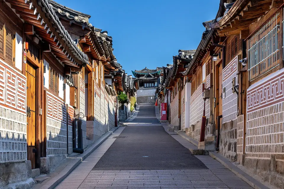 A sloping lane lined with traditional tiled-roof hanok houses in Seoul's Bukchon Hanok Village
