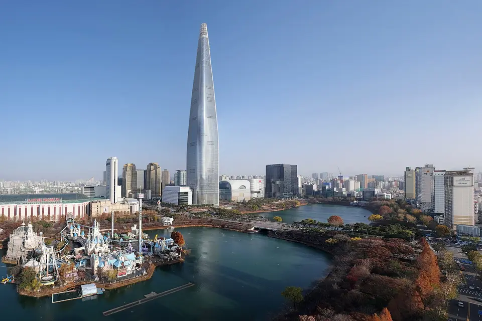 Lotte World Tower rising above Seokchon Lake and the Songpa district of Seoul in autumn