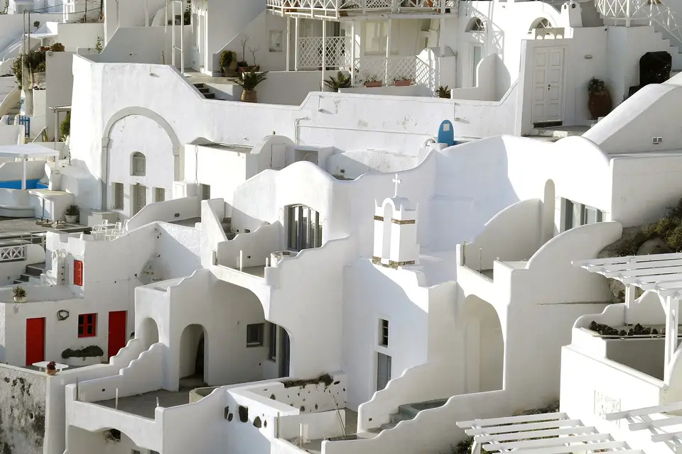 Whitewashed cave houses stepping down the caldera edge in Firostefani, just north of Fira
