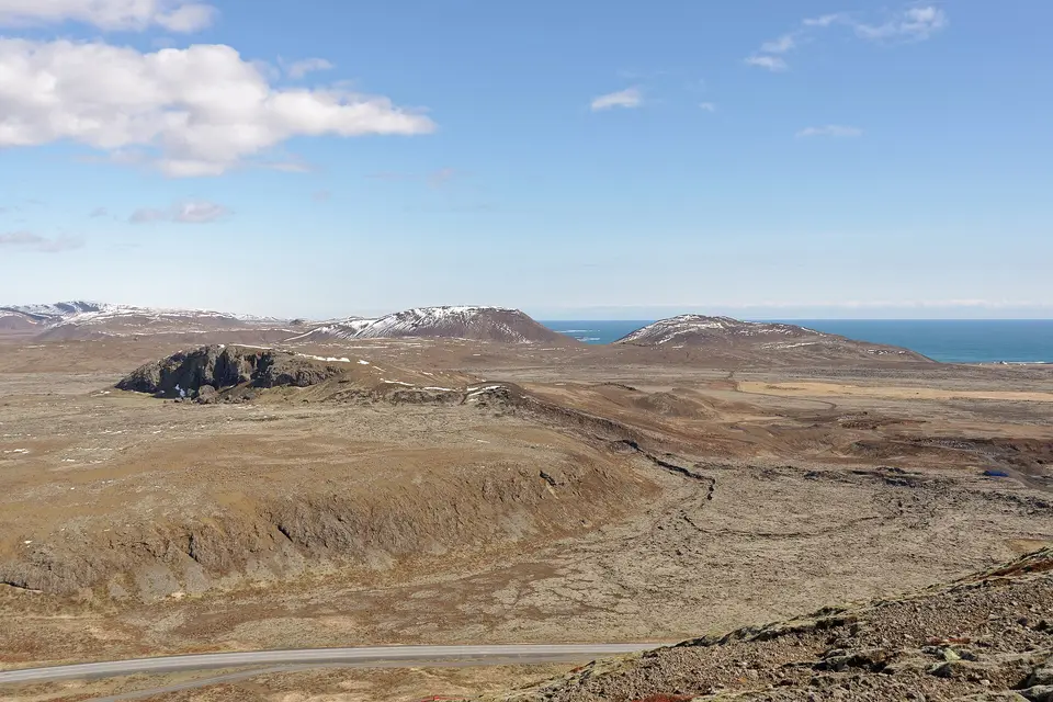 Lava fields, snow-dusted hills and the sea seen from Þorbjörn mountain near the Blue Lagoon
