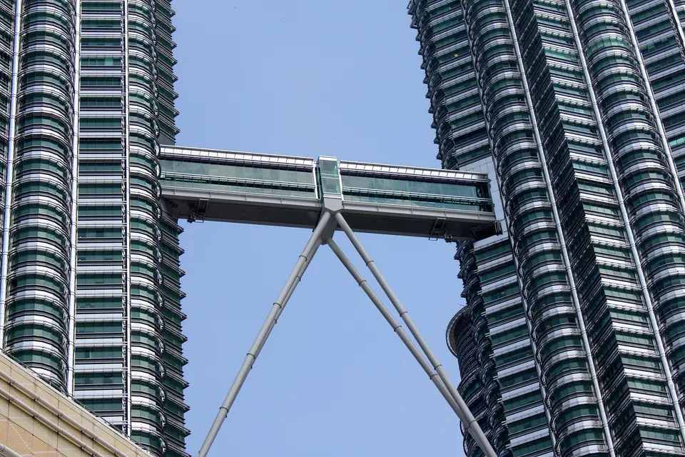 The double-deck skybridge linking the two Petronas Towers against a blue sky