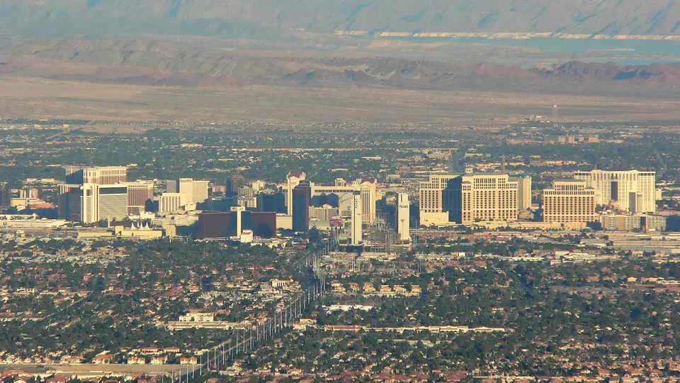 The hotel towers of the Las Vegas Strip rising from the desert valley in late afternoon haze