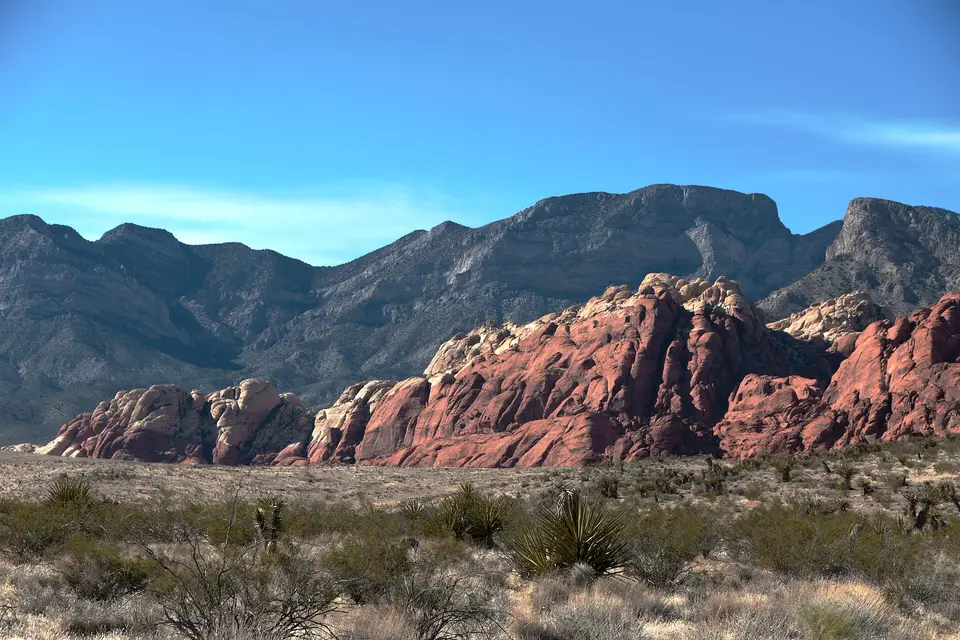 Red sandstone hills below grey limestone peaks in Red Rock Canyon, west of Las Vegas