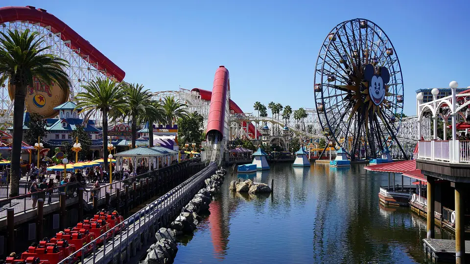 The lagoon at Pixar Pier in Disney California Adventure, with a roller coaster and Ferris wheel