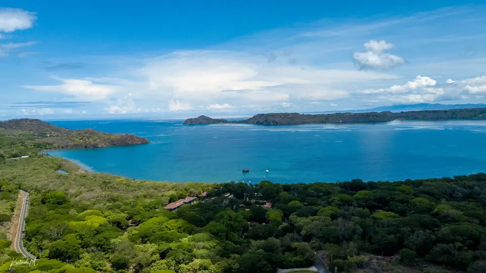 Forested hills above the blue water of Bahía Culebra near Playa Panamá, by the Papagayo Peninsula