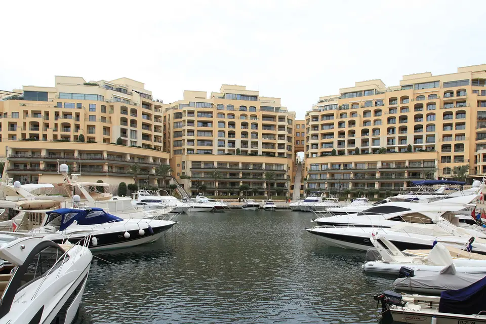 Motor yachts moored in Portomaso Marina below the curved apartment blocks of St Julian's