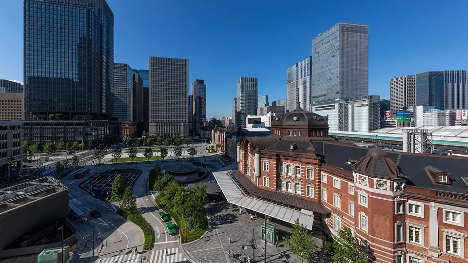 The red-brick Marunouchi building of Tokyo Station below the glass towers of central Tokyo