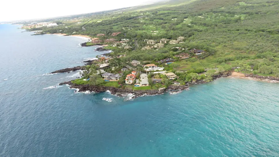 Aerial view of the rocky Wailea coastline, its villas and turquoise water on south Maui