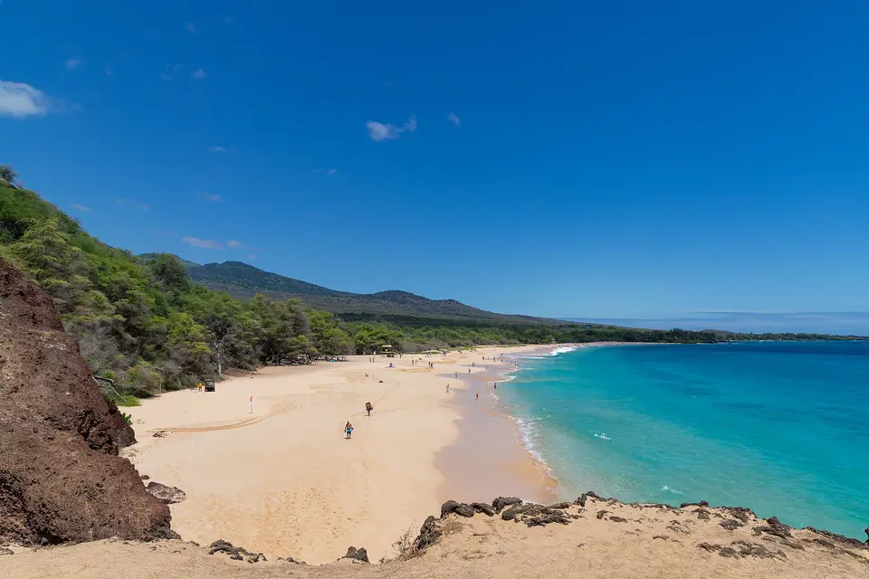 The long golden sand of Makena Big Beach, just south of Wailea, under a clear blue sky