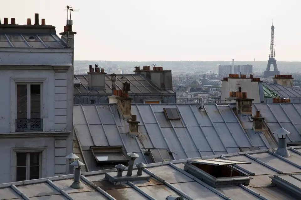 Zinc rooftops of Paris with the Eiffel Tower on the skyline