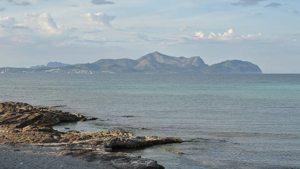 The mountains of the Alcúdia peninsula across the calm Bay of Alcúdia on Mallorca's north coast