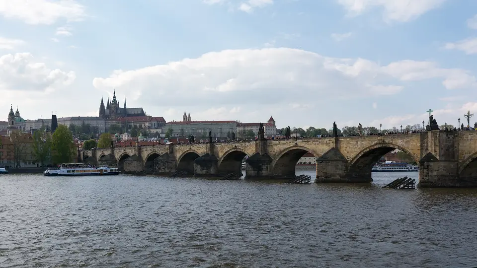 Charles Bridge crossing the Vltava in Prague, with the castle and St Vitus Cathedral on the hill behind