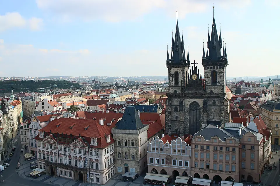 The twin spires of the Týn Church rising above the red rooftops of the Old Town in Prague
