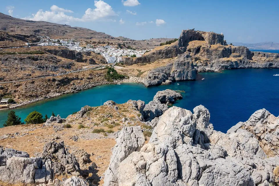 St Paul's Bay ringed by rocky headlands, with the white houses of Lindos beyond