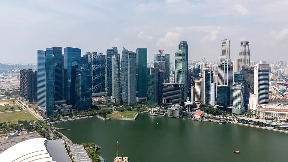 The towers of Singapore's Central Business District rising above the calm water of Marina Bay