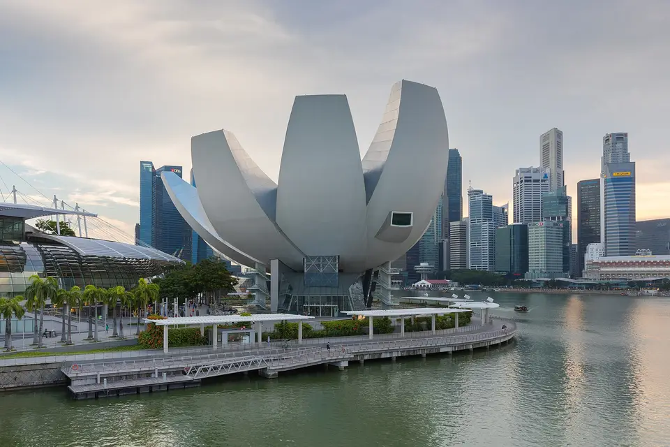 The lotus-shaped ArtScience Museum at Marina Bay in late afternoon, with the Singapore skyline behind