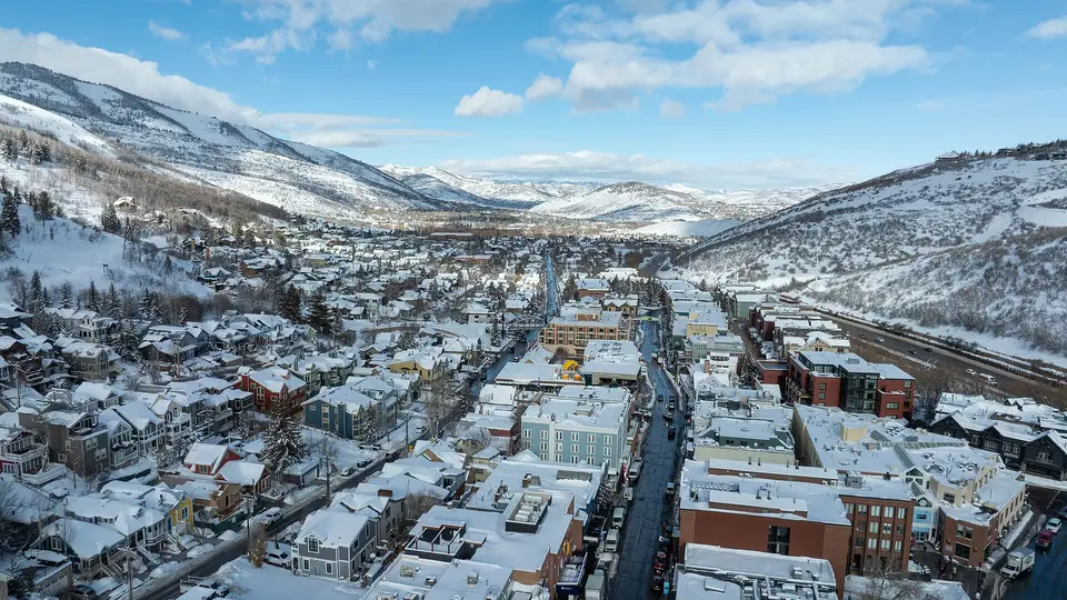 Aerial view over the snowy rooftops of Old Town Park City and the surrounding Wasatch ski slopes