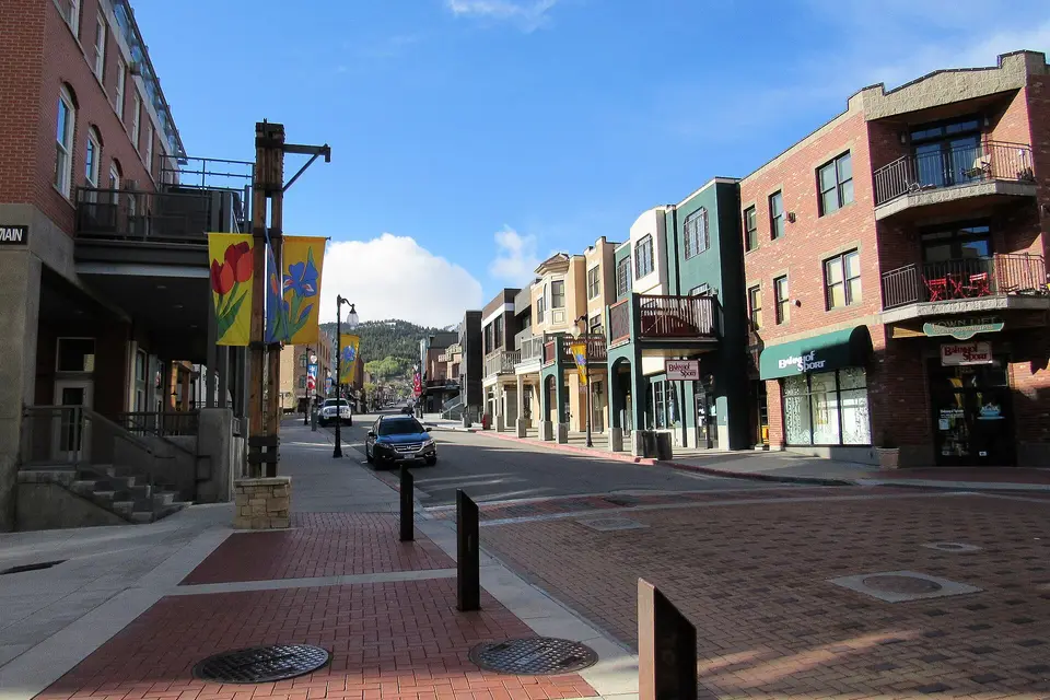Brick shopfronts and balconies along Main Street in Park City on a sunny day