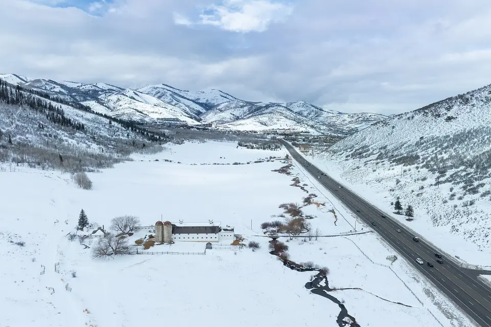 Snowy meadows and the highway leading into Park City between the Wasatch mountains in winter