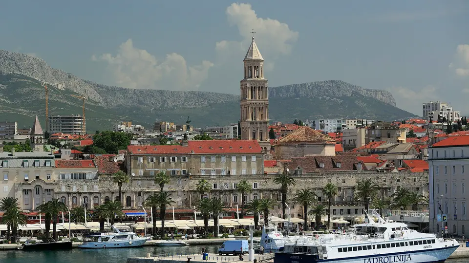 Split harbour and Diocletian's Palace with the cathedral bell tower and mountains rising behind
