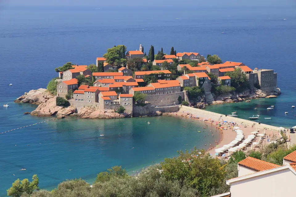 The walled island village of Sveti Stefan, joined to the shore by a sandy causeway
